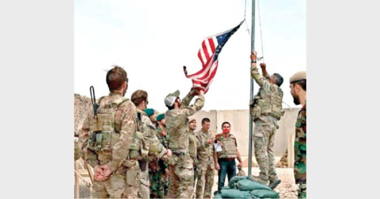 The US flag is taken down as troops hand over a military base to Afghan soldiers