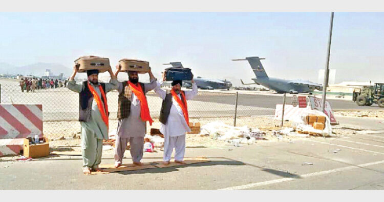 The devastating image of Afghan Sikhs leaving their country for India with three Saroops (holy copies) of Sri Guru Granth Sahib