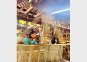Weaver (artist) weaving Pat silk bridal wear Mekhela-Sadar in a handloom in Sualkuchi, Assam