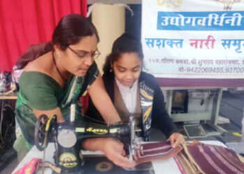 Woman engaged in sewing work at Udhyog Vardhini