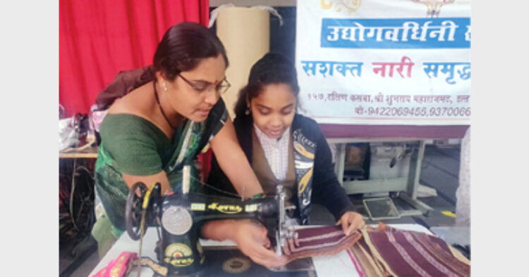 Woman engaged in sewing work at Udhyog Vardhini