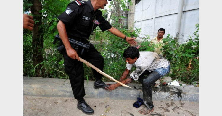 A Bangladeshi protester begs for mercy from a RAB official during a demonstration outside Dhaka, April 30, 2013 (Photo Credit: Benar News)