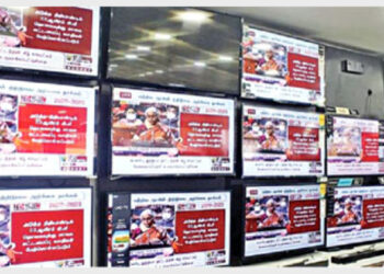 A person at a showroom watching the live telecast of Finance Minister Nirmala Sitharaman's tabling of the Union Budget
