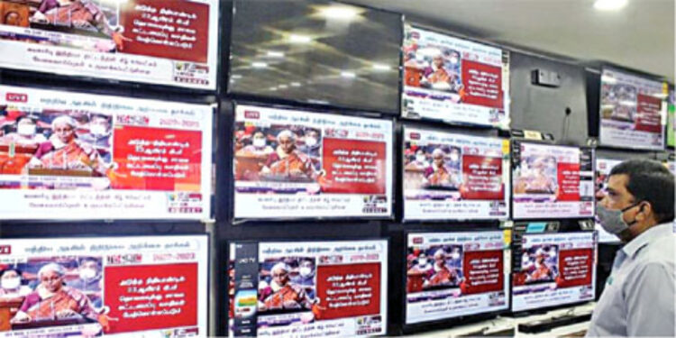 A person at a showroom watching the live telecast of Finance Minister Nirmala Sitharaman's tabling of the Union Budget