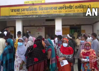 Voters at polling booth in Azamgarh (Photo Credit: ANI)