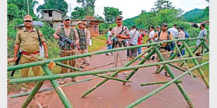 Assam Police personnel stand alert at Umlaper, a border village claimed by both Meghalaya and Assam