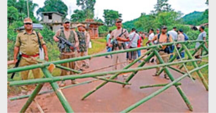 Assam Police personnel stand alert at Umlaper, a border village claimed by both Meghalaya and Assam