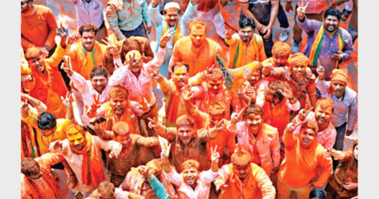 BJP supporters celebrate the party's victory in Uttar Pradesh Assembly elections at the State party office in Lucknow