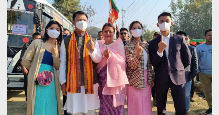 BJP candidate of Heirok assembly constituency Dr. Thokchom Radheshyam Singh with his family showing their inked fingers.