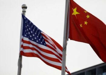 US-China flags outside the building of an American company in Beijing (Photo Source: Yahoo Finance)