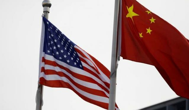 US-China flags outside the building of an American company in Beijing (Photo Source: Yahoo Finance)
