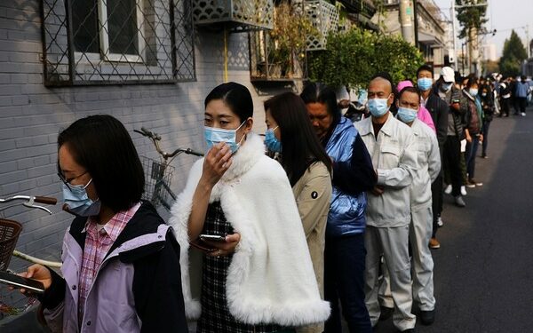 People line up outside a vaccination site after the city started offering booster shots of the vaccine against the coronavirus disease (COVID-19) to vaccinated residents, in Beijing, China  (REUTERS/Tingshu Wang)