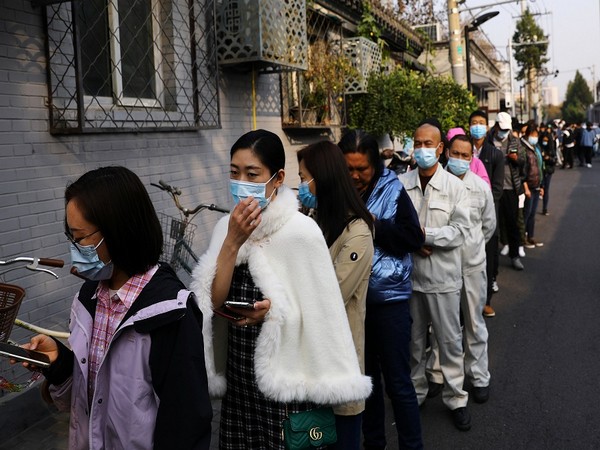 People line up outside a vaccination site after the city started offering booster shots of the vaccine against the coronavirus disease (COVID-19) to vaccinated residents, in Beijing, China  (REUTERS/Tingshu Wang)