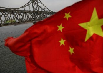 A Chinese flag is seen in front of the Friendship bridge over the Yalu River connecting the North Korean town of Sinuiju and Dandong in China's Liaoning Province  (Photo Source: REUTERS/Damir Sagolj)