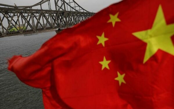 A Chinese flag is seen in front of the Friendship bridge over the Yalu River connecting the North Korean town of Sinuiju and Dandong in China's Liaoning Province  (Photo Source: REUTERS/Damir Sagolj)