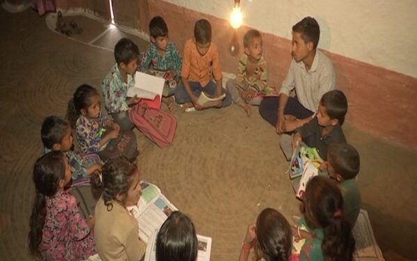 Children studying under light in Saddal (Photo Source: ANI)
