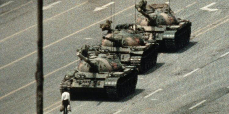 Man standing in front of tanks in Tiananmen Square (Photo Source: Getty Images)