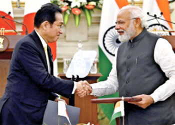 Prime Minister Narendra Modi and Japanese Prime Minister Fumio Kishida shake hands while exchanging agreements during the 14th India-Japan Annual Summit, in New Delhi on Saturday. (ANI Photo)