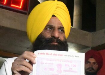 Jaswant Singh Gajjanamajra of AAP , MLA from Amargarh Vidhan Sabha showing the affidavit of one rupee salary and pension outside the Vidhan Sabha on Tuesday. Tribune Photo Pradeep Tewari