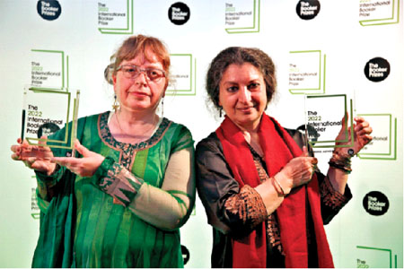 Author Geetanjali Shree, right, and translator Daisy Rockwell pose with the 2022 International Booker Prize author and translator awards respectively for Tomb of Sand, in London