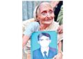 An old Hindu woman mourns the death of her relative in  Bangladesh