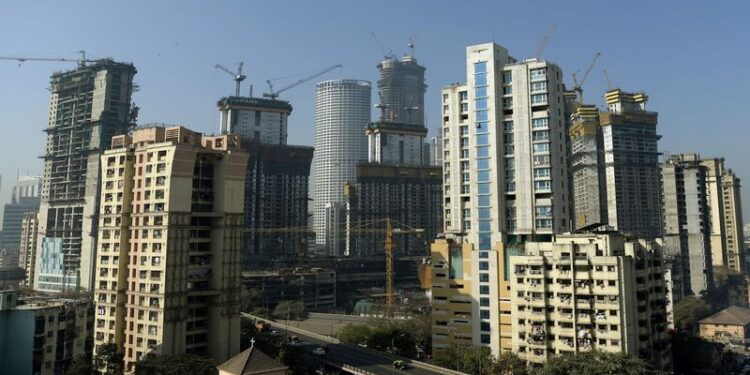 Under construction residential buildings rise into the skyline of Mumbai on January 27, 2017. / AFP / PUNIT PARANJPE        (Photo credit should read PUNIT PARANJPE/AFP/Getty Images)