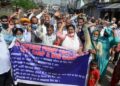 Refugees from PoJK and their supporters hold a banner and shout slogans during their protest over various demands in Jammu on March 30, 2021. (ANI Photo)