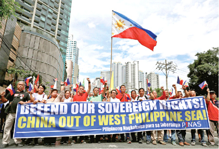 Filipino activists and opposition leaders march to protest against the presence of Chinese vessels in South China Sea at the Chinese Embassy in Makati City, Philippines