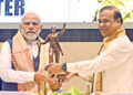 Prime Minister Narendra Modi being presented with a statue of Ahom General Lachit Barphukan by Assam Chief Minister Himanta Biswa Sarma at the valedictory function on his 400th birth anniversary