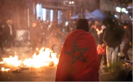 Moroccan supporters light up a fire in a street after Morocco’s football team lost in Fifa  World Cup semi-final  against France, in Brussels