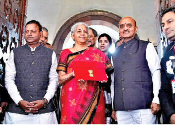 Union Finance Minister Nirmala Sitharaman, along with MOS Bhagwat Kishanrao Karad and Pankaj Chaudhary, holds up a folder with the Government of India’s logo before leaving  her office to present the  Budget in the Parliament on February 1, 2023