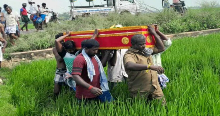 Dalit people carry deadbody for cremation wading through paddy field in Tamil Nadu