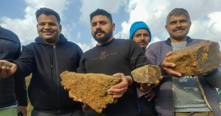 Residents of Salal village pose for photos showing lithium stones, in Reasi District on February 11, 2023