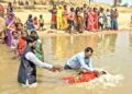 Villagers being baptised on the banks of a river in Bihar