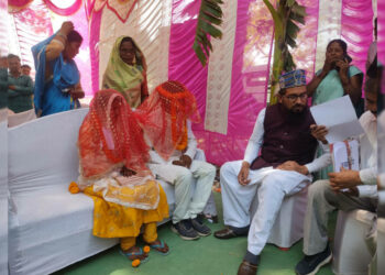 Basanti and Haroon at the wedding mandap with the cleric