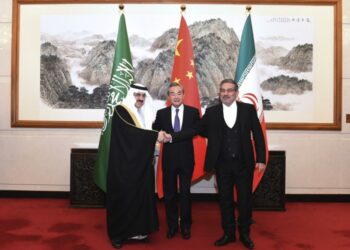 Ali Shamkhani, the secretary of Iran’s Supreme National Security Council, at right, shakes hands with Saudi national security adviser Musaad bin Mohammed al-Aiban, at left, as Wang Yi, China’s most senior diplomat, looks on, at centre, for a photo during a closed meeting held in Beijing, March 11, 2023