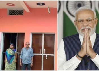 ( Family standing in front of the house built under Pradhan Mantri Awas Yojana )