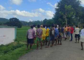 Locals assembled near a field