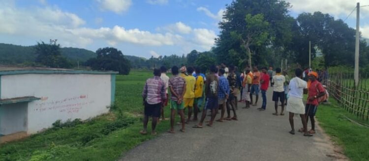 Locals assembled near a field