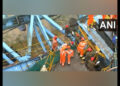 Rescue workers at the site of collapse of girder launching machine