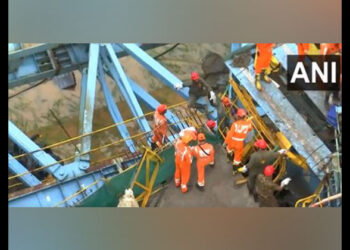 Rescue workers at the site of collapse of girder launching machine