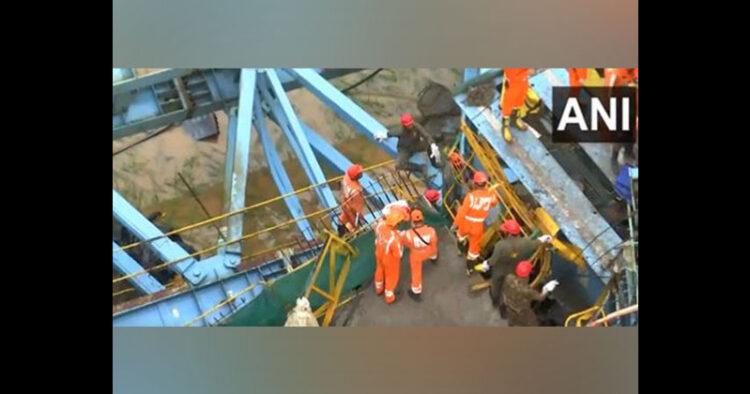 Rescue workers at the site of collapse of girder launching machine