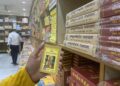 A visitor at Gita Press book stall holding the pocket size Hanuman Chalisa (Photo: Nishant Kumar Azad)