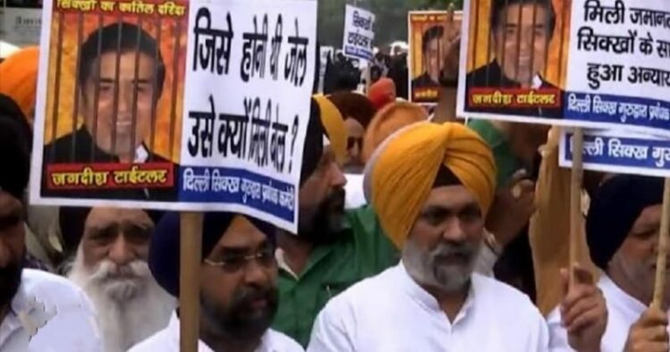 Sikh community members protest outside court in Delhi