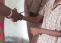 Teacher cutting the sacred thread off a Hindu student's hand in Tamil Nadu (Facebook)