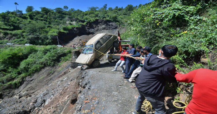 Himachal Pradesh: People try to pull out a car that fell down due to a landslide amid heavy rainfall
