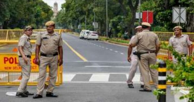 Delhi Police personnel stand guard near Raisina Road ahead of the upcoming G20 Summit