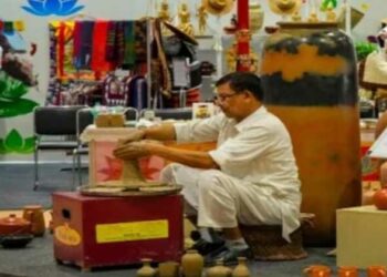 An artisan works on a handicraft artwork at G20 Crafts Bazaar