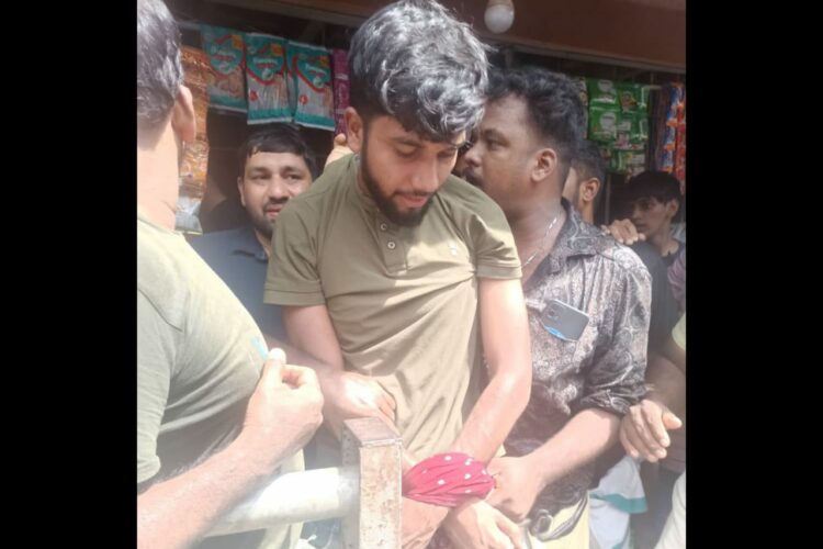 The accused Mohammad Arshad held by the locals after he attacked the minor victim with a knife (X)