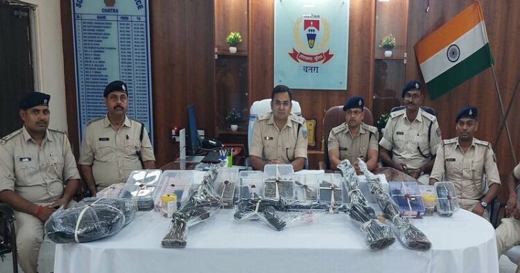 Police team with seized arms and ammunitions